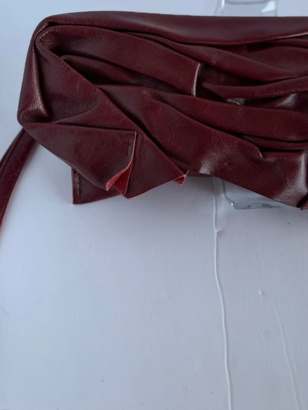 Burgundy Pleated Leather Handbag Featuring a Soft Ruched Design